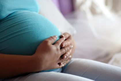 Young mother’s pregnant belly